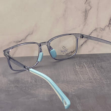 Load image into Gallery viewer, Sky blue colour eyeglasses with blue light lens for children age 9years.yeglasses with light blue arms on a marble and stone surface