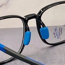 Load image into Gallery viewer, Close-up of black eyeglasses with blue temples attached with blue light blocking lens. 
