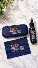 Load image into Gallery viewer, A dark navy blue Esquire ETC branded spray bottle with a black spray top, shown next to its matching hard case and microfiber cloth on a light marble surface.
